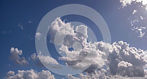 Rain clouds buildup panorama in blue sky.