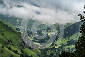 Rain clouds over a green mountain valley photo