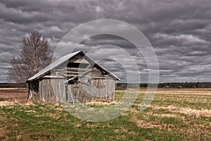 Rain Clouds Over The Old Barn House