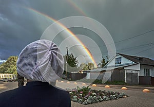 Rain clouds in which a real rainbow has formed, I am in nature. Double rainbow, cumulus clouds, heavy rain, selective focus