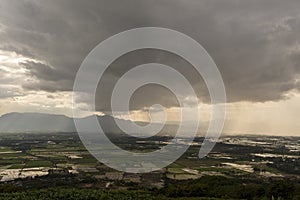 Rain curtaining a view of the mountains.Rain storm over Rice fie