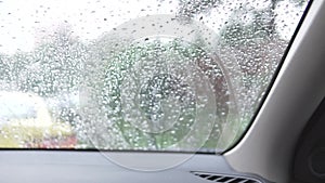 Rain dripping on the windshield of the car window