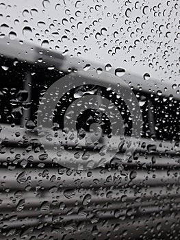 Rain drips covered side glass of moving car