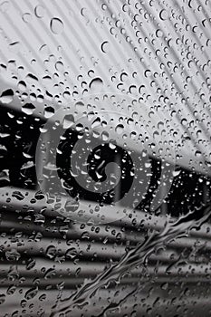 Rain drips covered side glass of moving car