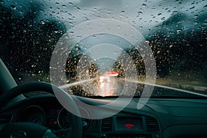 Rain drizzle on windshield in evening, driving in bad weather