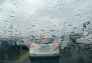 Rain drop on the car glass background.Road view through car window with rain drops, Driving in rain.