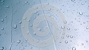 Rain drop on the car glass background.Road view through car window with rain drops, Driving in rain. Abstract traffic in raining d