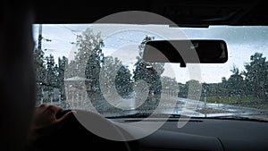 Rain drop on the car glass background.Road view through car window with rain drops, Driving in rain. Abstract traffic in raining d