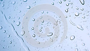 Rain drop on the car glass background.Road view through car window with rain drops, Driving in rain. Abstract traffic in raining d