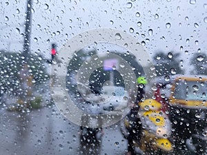 Rain drop on the car glass. Road TRAFFIC view through car window with rain drops, monsoon season in Maharashtra, India