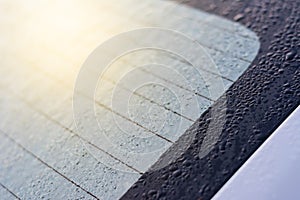 Rain drop on car`s mirror with light