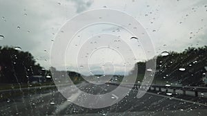 Rain drop falling on car windshield