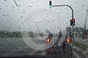 Rain drop falling on car windshield