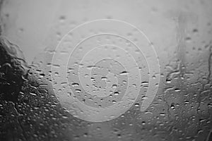 Rain drop on a glass with focus on a center, high contrast black and white picture style