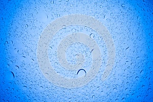 Rain droplets on blue glass background, Water drops on blue glass