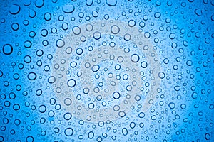 Rain droplets on blue glass background, Water drops on glass