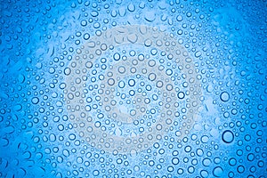 Rain droplets on blue glass background, Water drops on glass