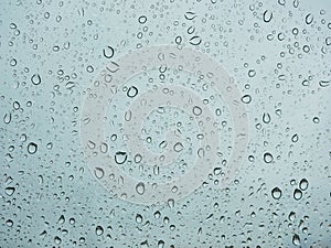 Rain droplets on a car`s window on a rainy day - driver`s perspective