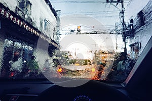 Rain droplets on car windshield.