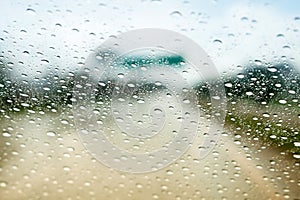 Rain droplets on car windshield, blocked traffic