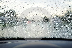 Rain droplets on car windshield, blocked traffic