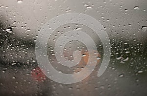 Rain droplets on car windshield, blocked traffic