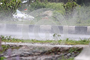 Rain droplets drifted up after a vehicle passed