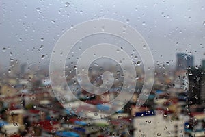 Rain droplets on a window with a city view