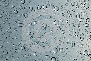 Rain drops on car front window in rainy day