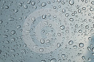 Rain drops on car front window in rainy day
