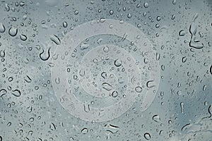 Rain drops on car front window in rainy day