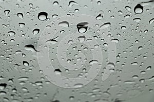 Rain drops on car front window in rainy day