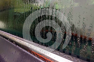 Rain drops on car glass close-up, background