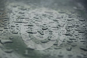 Rain drops on car with glass coating skin