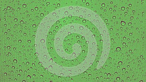 Rain drops on car glass. Green panorama background, toned