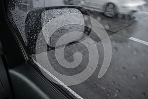 Rain drops on car side mirror