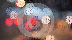 Rain Drops on Car Window Glass with Blurred Night City Car Lights Bokeh as Background. 4K.