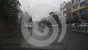 Rain drops on cars windshield during heavy monsoon rains in India