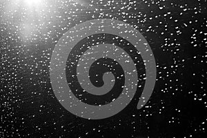 Rain drops and defocused sky background in black and white