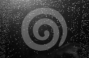 Rain drops and defocused sky background in black and white