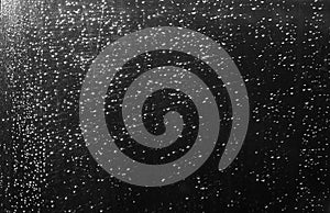 Rain drops and defocused sky background in black and white