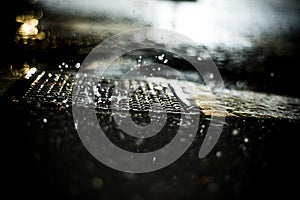 rain drops falling on pavement by night