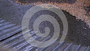 Rain Drops Flow Down, Fall from the Roof in a Puddle During Pouring Rain. 4K