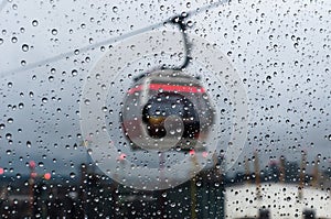 Rain drops on a glass as a cable car passes by