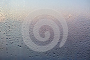 Rain drops on glass background. Pattern of water drops after heavy rain, View from indoor. Abstract wet texture. Transparent drops