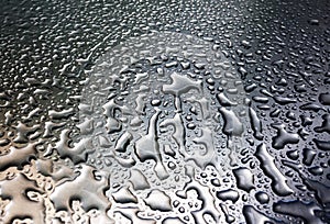 Rain drops on gray metal surface