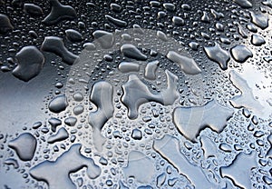 Rain drops on gray metal surface