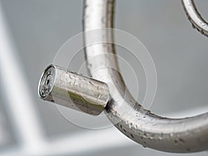 Rain drops on a gray metallic construction  of chrome bars