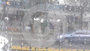 Rain drops on mirror with car moving scenery on rainy day