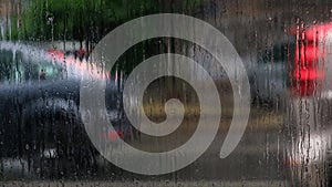 Rain drops on rainy day on outside window glass